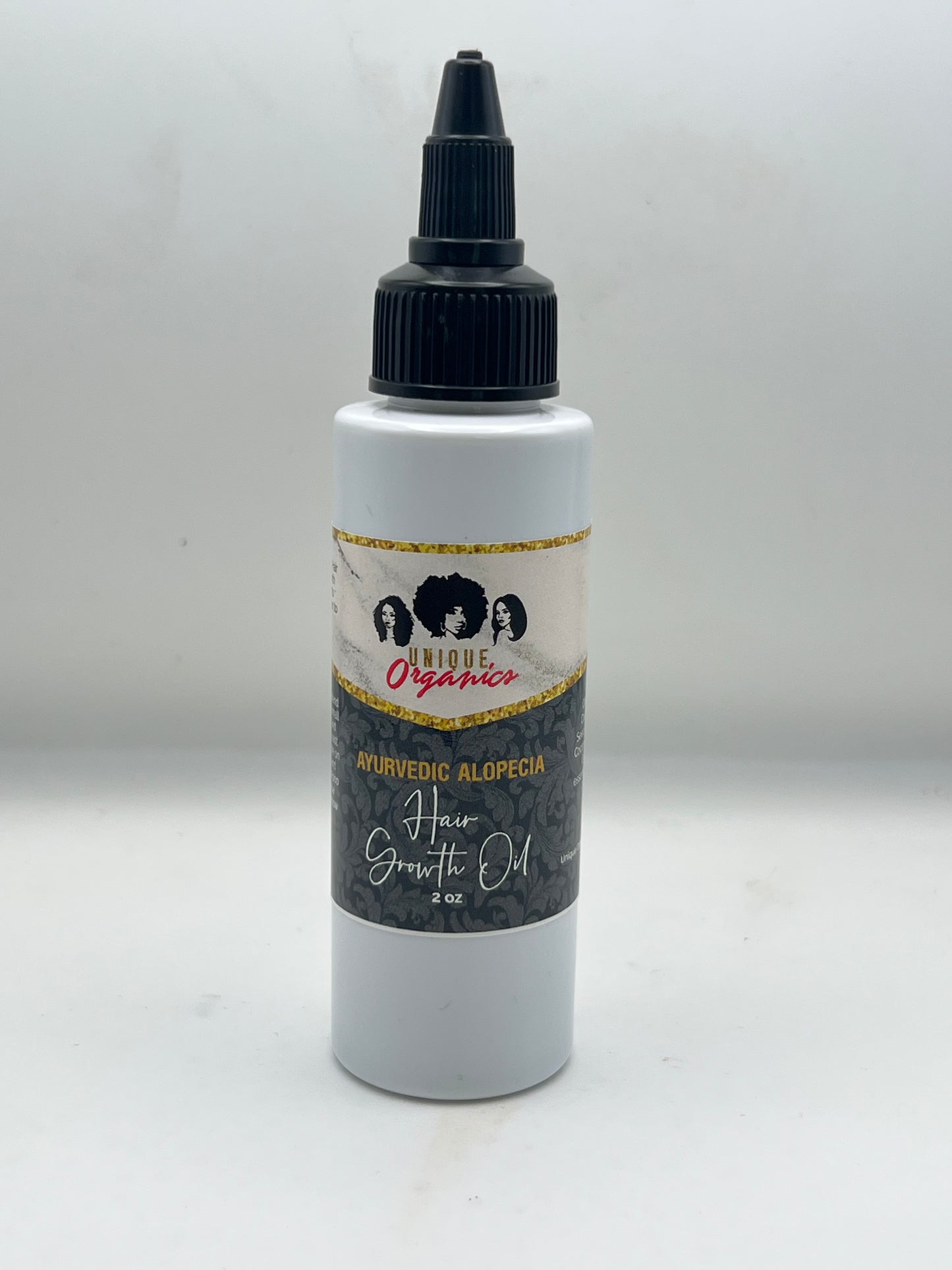 Bottle of hair product with a label on a white background